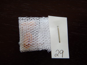 Fixed tissues can be rolled into mosquito net pouches, labeled with pencil on waterproof paper, and closed with a staple. I fix my tissues in cassettes first since I have some and they don't deform the tissues. The net pouches are good for storing the tissues so I can re-use the few cassettes I have.