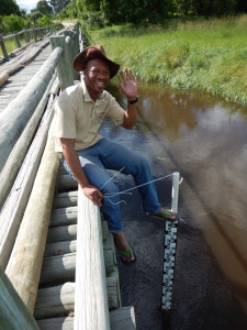 Mothobi installing a conductivity/temperature data logger at Khwai.